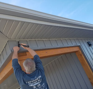 carpenter installs siding on home Seamless Experts residential and commercial exterior remodeling Ozarks Missouri